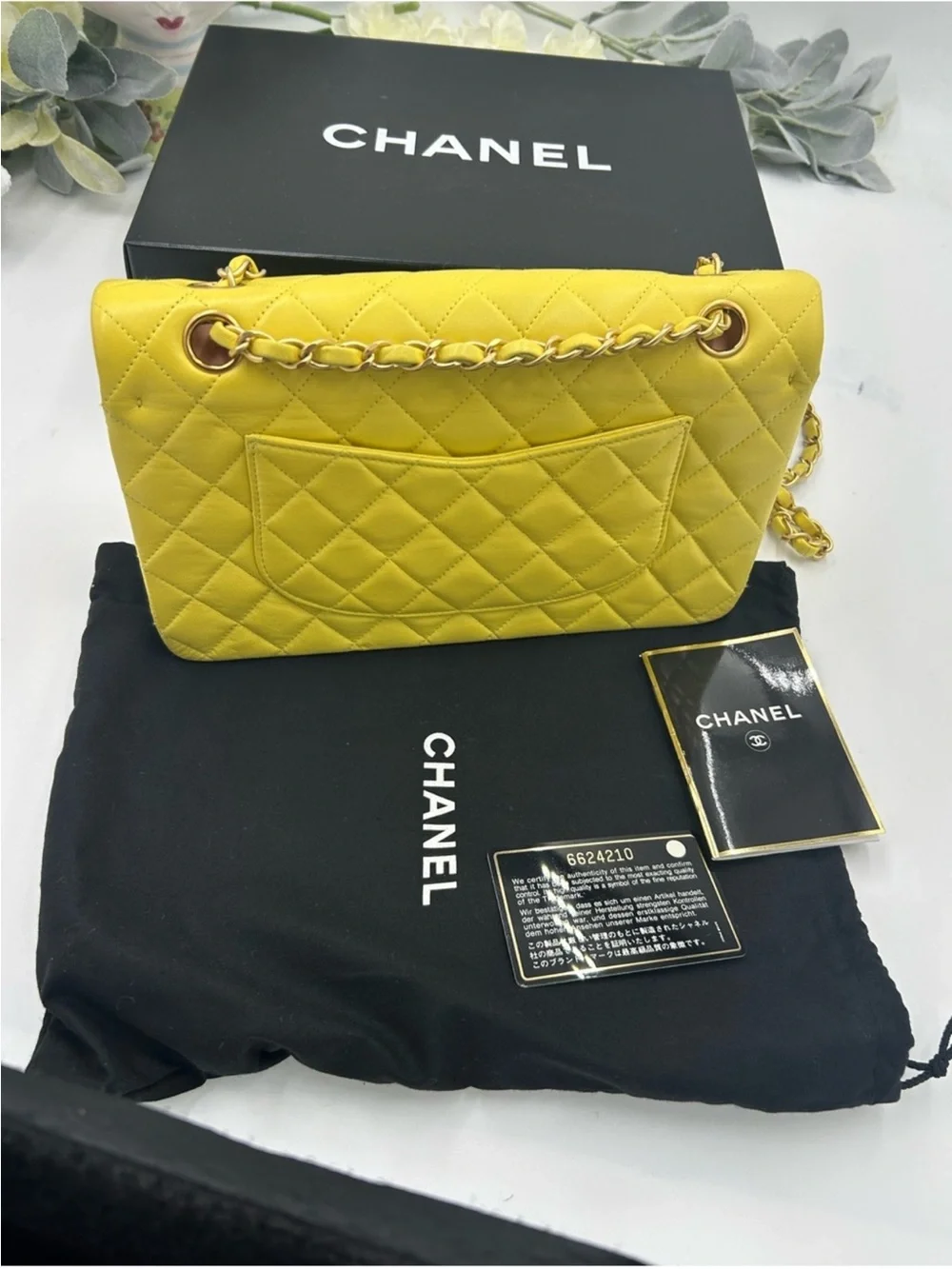 CHANEL CLASSIC QUILTED double flap bag . Yellow with gold hardware .
